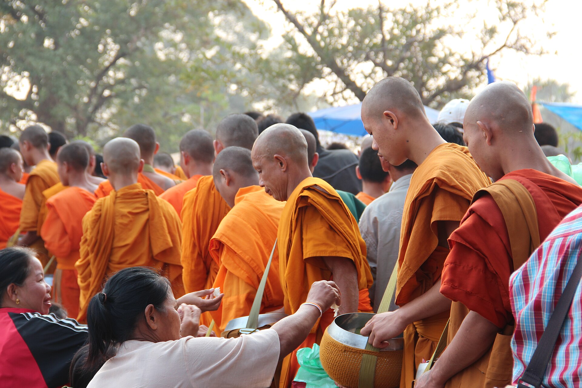 Morning alms offering to monks during the Boun Wat Phou festival in Champasak